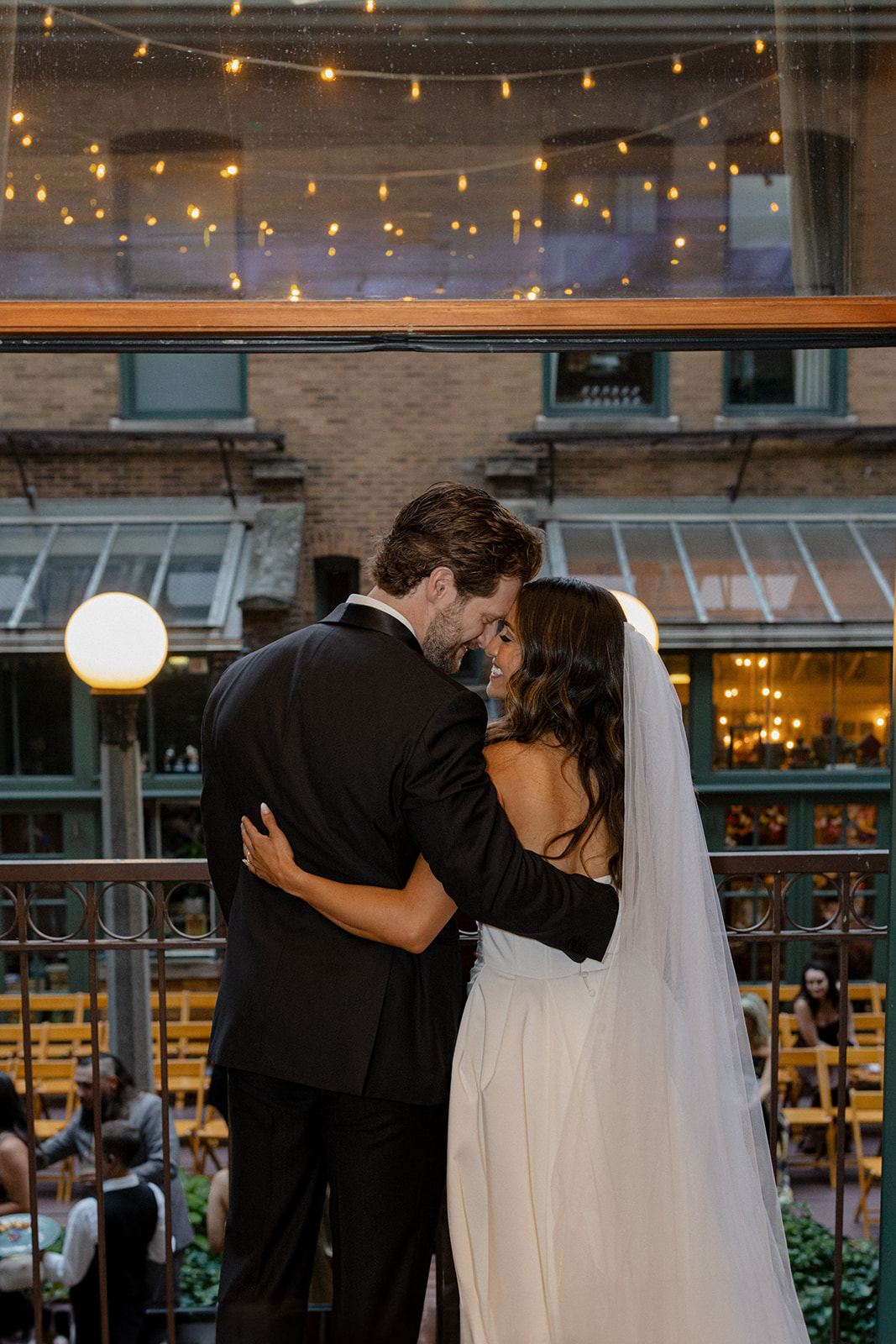 Bride and groom embracing at The Ivy Room in Chicago during golden hour, photographed in a candid documentary style