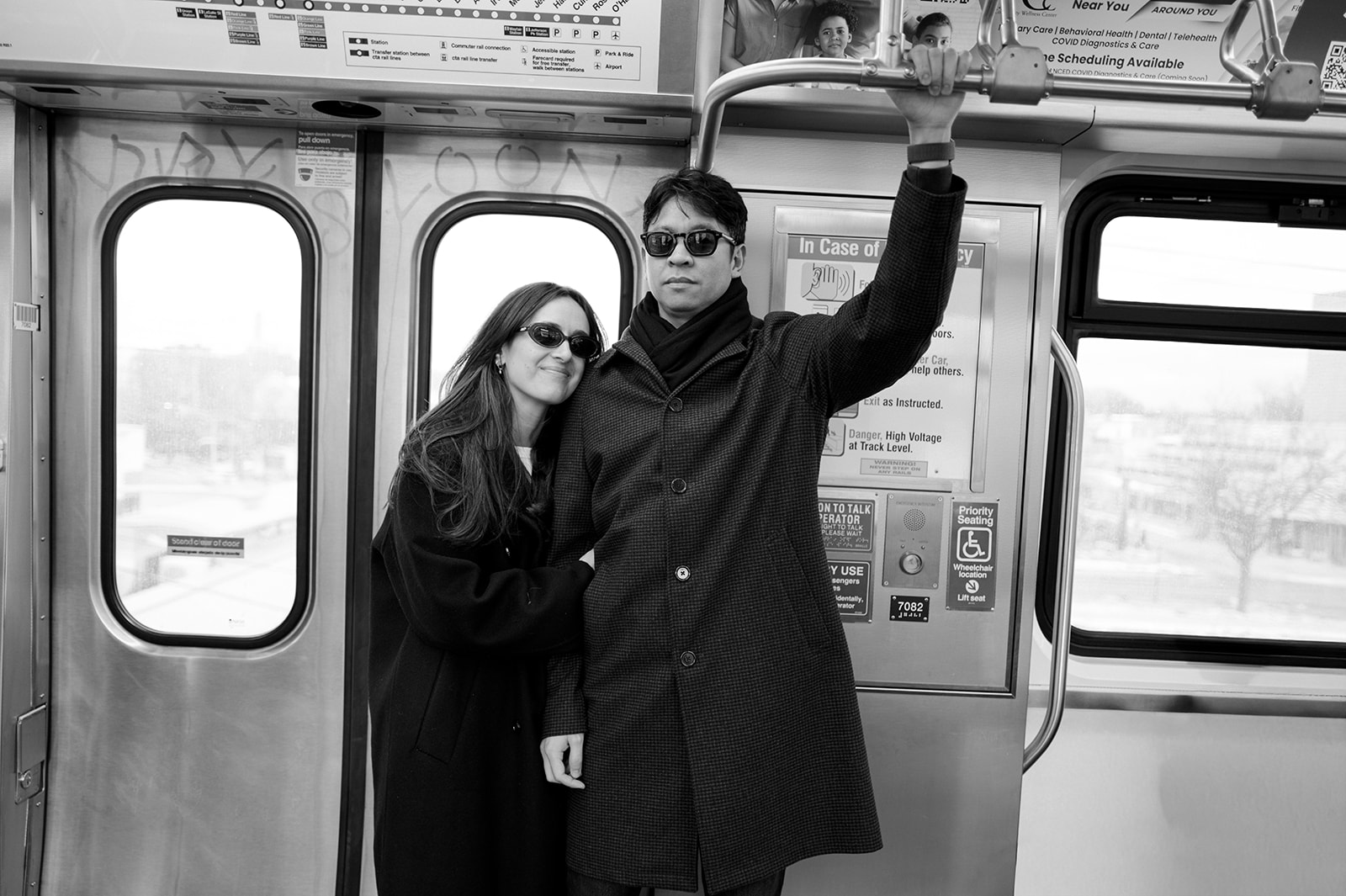 Couple standing together inside a Chicago CTA train during their Blue Line engagement session
